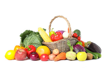 Wicker basket and different vegetables isolated on white background