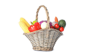 Wicker basket with vegetables isolated on white background