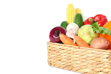 Wicker basket with vegetables isolated on white background