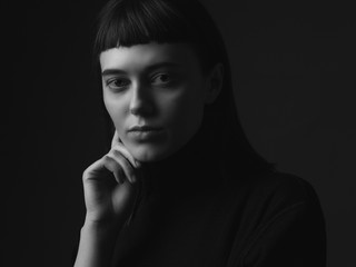 Close up portrait of young woman. Black and white. Low key