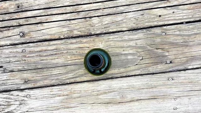 revealing shot, looking down view of the bottle taken from above, top view, funny and interesting.