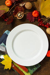 Autumn rustic table. Thanksgiving or autumn harvest table setting with rustic silver on a wooden...