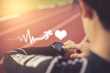 Women measuring heart rate with a watch after running