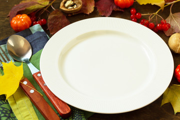 Autumn rustic table. Thanksgiving or autumn harvest table setting with rustic silver on a wooden table. Free space for your text.