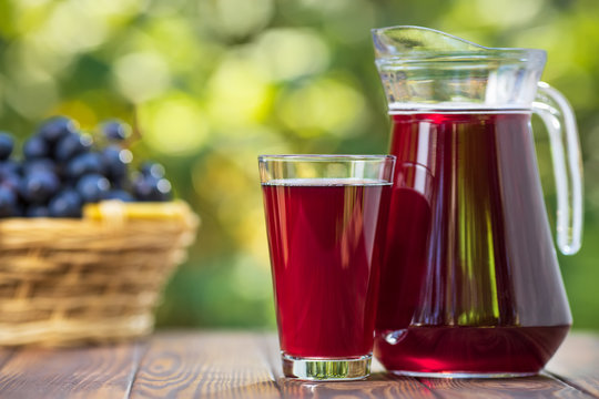 grape juice in glass and jug
