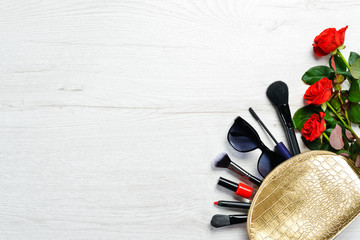 Women's handbag and red roses. Top view. Free copy space.