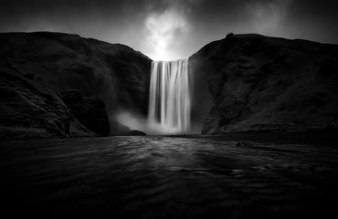 Black and white view to stunning Skogafoss waterfall - obrazy, fototapety, plakaty