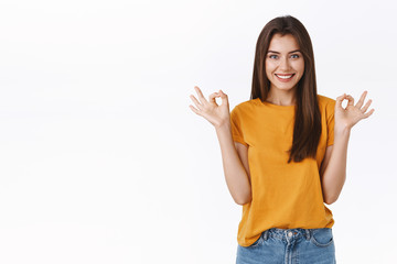 Cheerful, confident happy smiling girl have everything under control, assuring all okay, show ok excellent gesture, give approval, accepting or like awesome product, recommend something