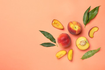 Flat lay composition with sweet juicy peaches and space for text on orange background