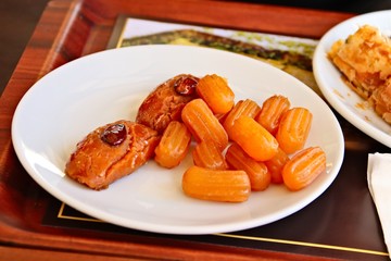 Turkish dessert (tulumba and sekerpare) on a white plate. Turkey food background. 