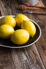 Fresh lemon fruits on rural table, preparing autumn hot drink