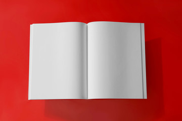 Empty book pages on red background, top view. Mockup for design