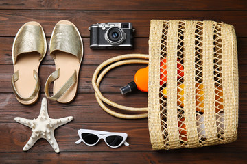 Flat lay composition with beach objects on wooden background