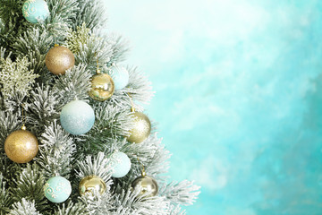 Beautiful Christmas tree with decor against light blue background. Space for text