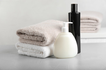 Fresh towels and toiletries on light grey stone table