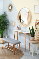 Stylish room interior with little table and comfortable bench