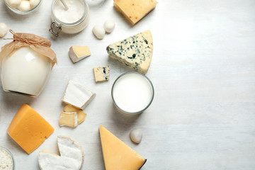 Different delicious dairy products on white table, flat lay. Space for text