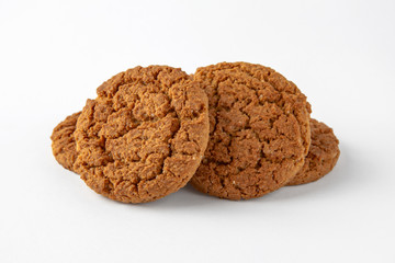 Tasty crunchy cookie: oatmeal, shortbread, chocolate, nutty, honey. Close-up isolated on a white background