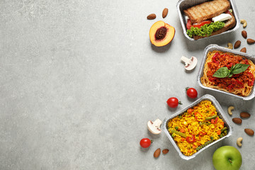 Lunchboxes on light grey table, flat lay. Healthy food delivery
