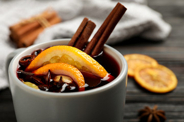 Cup of tasty mulled wine with spices, closeup