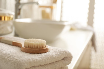 Hairbrush on towel on countertop in bathroom