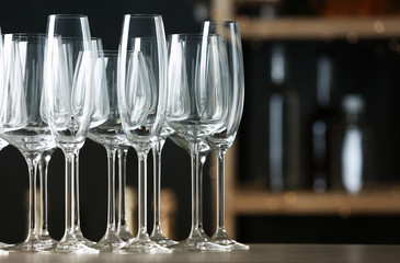 Empty clean glasses on counter in bar, space for text