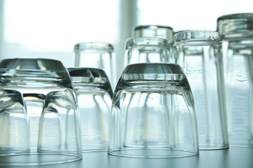 Empty glasses on grey table against blurred background, closeup