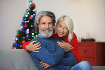 Happy mature couple celebrating Christmas at home