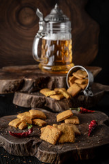 Snack for beer, alcohol. Crispy and crumbly delicious Salty and spicy cookies with seeds, chili peppers, spices and salt. Stylish still life for poster.