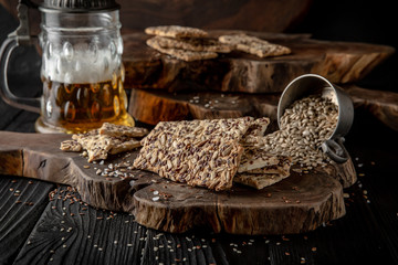 Snack for beer, alcohol. Crispy and crumbly delicious Salty and spicy cookies with seeds, chili peppers, spices and salt. Stylish still life for poster.