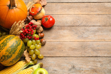 Obraz na płótnie Canvas Flat lay composition with autumn vegetables and fruits on wooden background, space for text. Happy Thanksgiving day