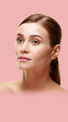 Beautiful woman with healthy face skin on pink background. Aspect ratio and vertical position...