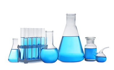Set of laboratory glassware with blue liquid on white background
