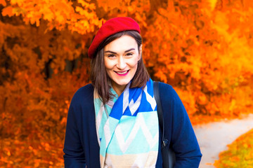 Young happy woman in autumn park