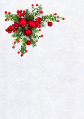 Christmas decoration. Twigs christmas tree, christmas red balls and red berries on snow with space for text. Top view, flat lay