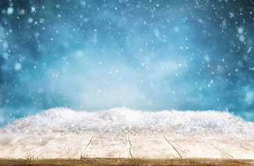 Beautiful winter background with wooden old desk and blurred blue sky. Winter, New Year and...