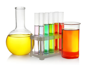 Laboratory glassware with colorful liquids on white background