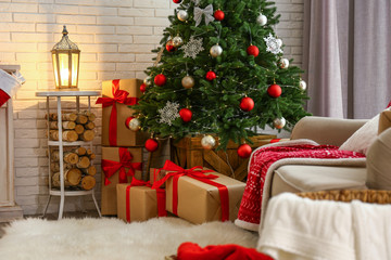 Fototapeta na wymiar Stylish interior with beautiful Christmas tree and gift boxes