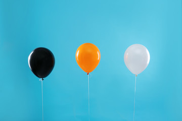 Colorful balloons on blue background. Halloween party
