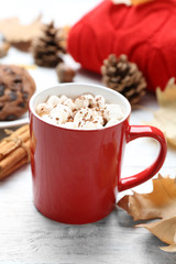 Cup of hot drink and cookies on white wooden table. Cozy autumn atmosphere