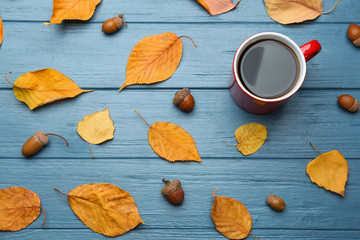 Flat lay composition with cup of hot drink on blue wooden table. Cozy autumn atmosphere