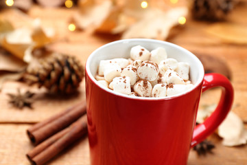 Cup of hot drink on wooden table, closeup. Cozy autumn atmosphere