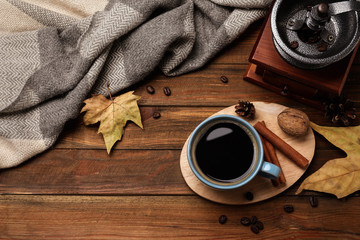 Flat lay composition with cup of hot drink on wooden table. Cozy autumn atmosphere