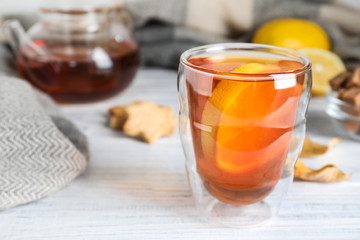 Cup of hot drink on white wooden table. Cozy autumn atmosphere
