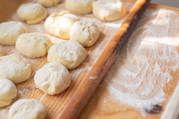 Fototapeta na wymiar langos, raw dough with cheese on a wooden board