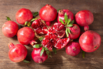 fresh ripe pomegranates with leaves, top view