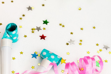 Birthday party background. party whistle, streamers and confetti with copy space