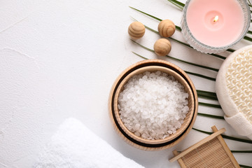 Flat lay composition with sea salt on white background, space for text. Spa treatment