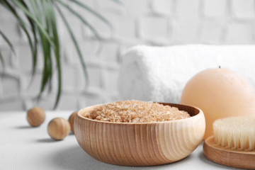 Fototapeta na wymiar Salt for spa scrubbing procedure in wooden bowl on white table