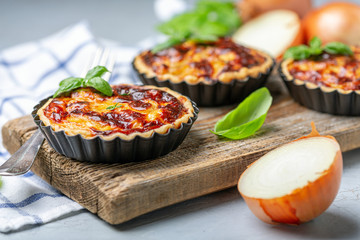 Homemade onion open mini pies. © Saprunova Marina
